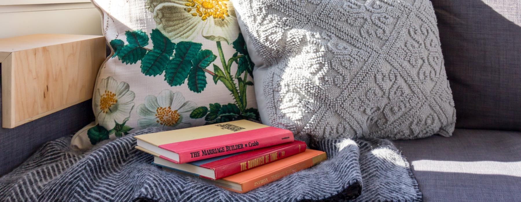 a pillow and books on a bed